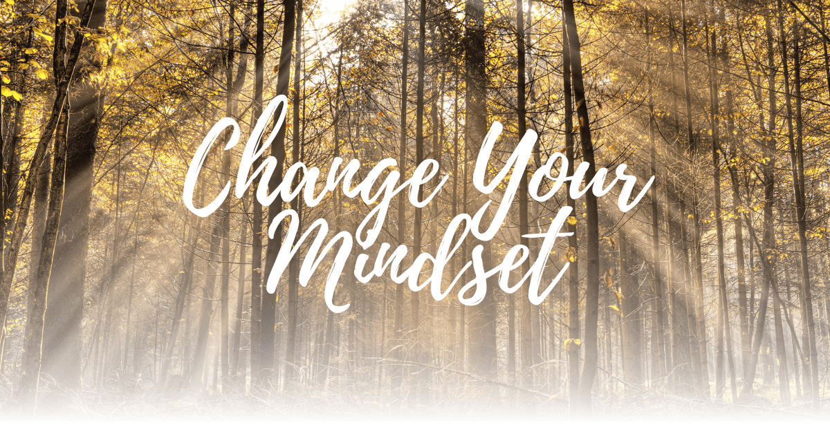 Image of forest with the sun peering through with the phrase, "Change Your Mindset."